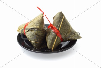 Two wrapped Chinese rice dumplings