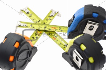 Measuring tapes criss crossing each other