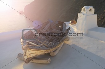 Old boat on the roof in Santorini with sea view