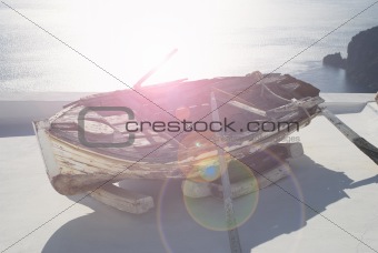 Old boat on the roof in Santorini with sea view