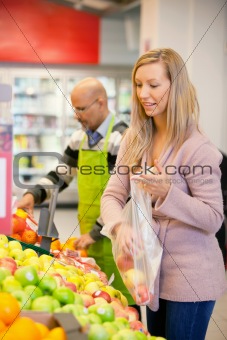 Young woman buying fruits