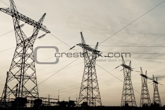 Pylon and transmission power line in sunset