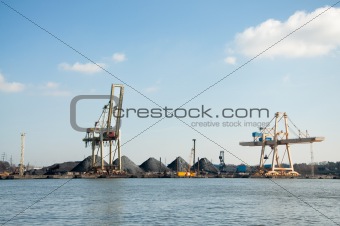 slag heaps of coal on the wharf in the port 