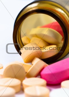 A bottle of pills on white isolated background