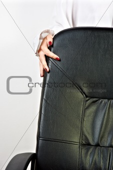 Business chair with a hand of a girl