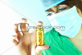 Doctor holding a bottle of pills in her hand 