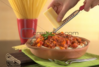 Grating Cheese over Spaghetti Bolognaise