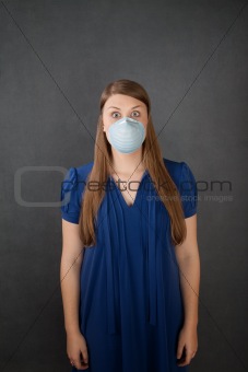 Scared woman wearing surgical mask