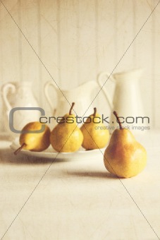 Fresh pears on old wooden table with vintage feeling