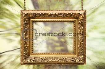 Gilded frame hanging with  abstract background