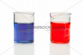 Red and blue liquid in beakers