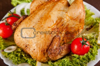 Close-up of roast chicken with fresh vegetables 