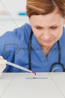 Female scientist preparing a microscope slid