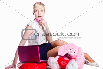 blond girl working with pink laptop on isolated white