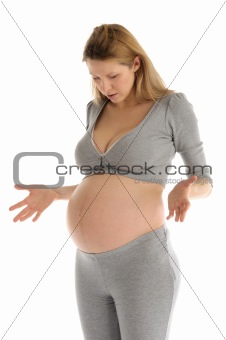 astonished pregnant woman in gray suit
