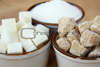 Several types of sugar - refined sugar, brown sugar and granulated sugar