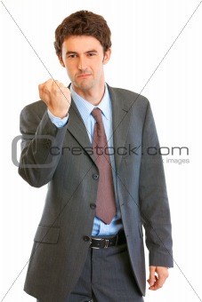  Angry modern businessman threaten with fist
