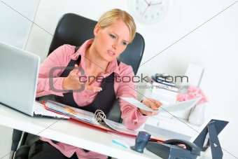 Sitting at office desk business woman dissatisfied with bad results of work 
