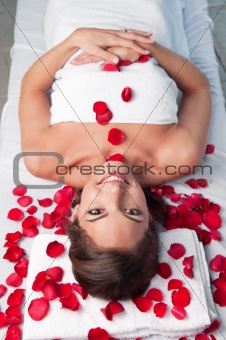 Smiling beautiful woman lying on a massage table