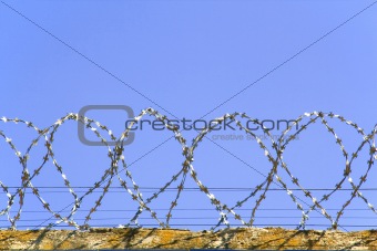 Barbed wire on a background of blue sky