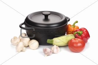 black cast-iron cauldron with vegetables