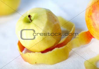 Yellow apple with peeled twisted skin