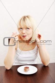 Beautiful woman eating cake.
