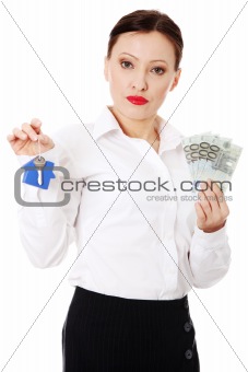 Beautiful businesswoman holding euros bills and hose keys