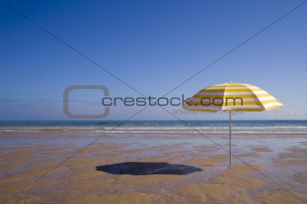yellow umbrella at the beach