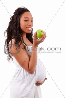 Pregnant african american woman eating an apple