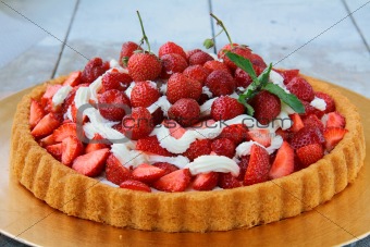 Plate with homemade strawberry tart with whipped cream