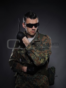 portrait of soldier in camouflage and ammunition with knife.