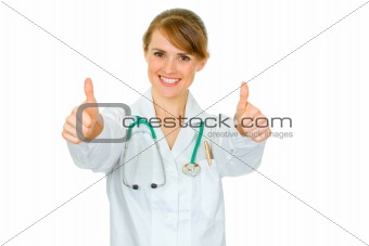 Smiling medical doctor woman showing thumbs up gesture
