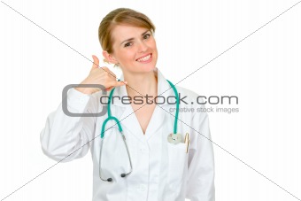 Smiling medical female doctor showing contact me gesture
