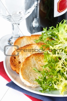 Crusty toasts and salad.