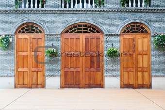 Traditional Chinese  house with wooden arch doors and deck.