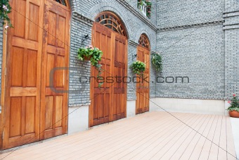 Traditional Chinese  house with wooden arch doors and deck.
