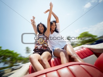 beautiful twin sisters having fun in cabriolet car