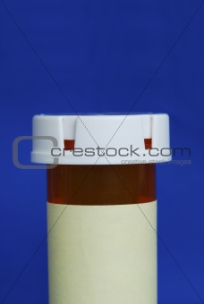 Medicine bottle with yellow label isolated on blue background.