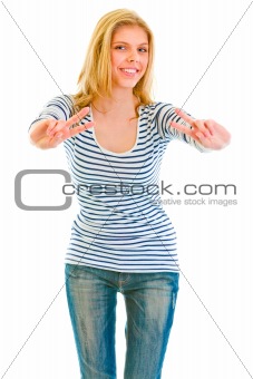 Smiling beautiful teen girl showing victory gesture
