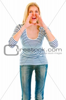 Funny beautiful teen girl shouting through megaphone shaped hands
