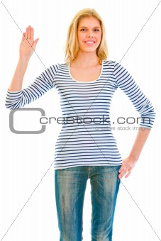 Smiling beautiful teen girl showing salutation gesture
