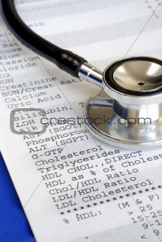 A stethoscope on the top of a blood test report isolated on blue
