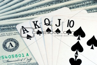 The Royal Flush on the top of some dollar bills