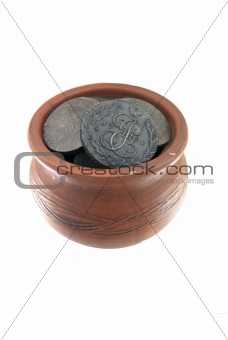 Old traditional clay mug with ancient coins