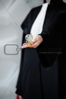 Barrister in wig holding globe in hand