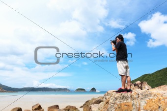 Photographer taking photo on beach