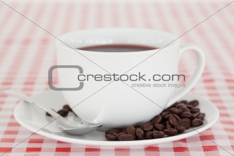 Coffee and beans on a tablecloth