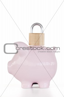 Side view of pink piggy bank and padlock