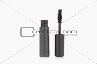 A black mascara brush and tube